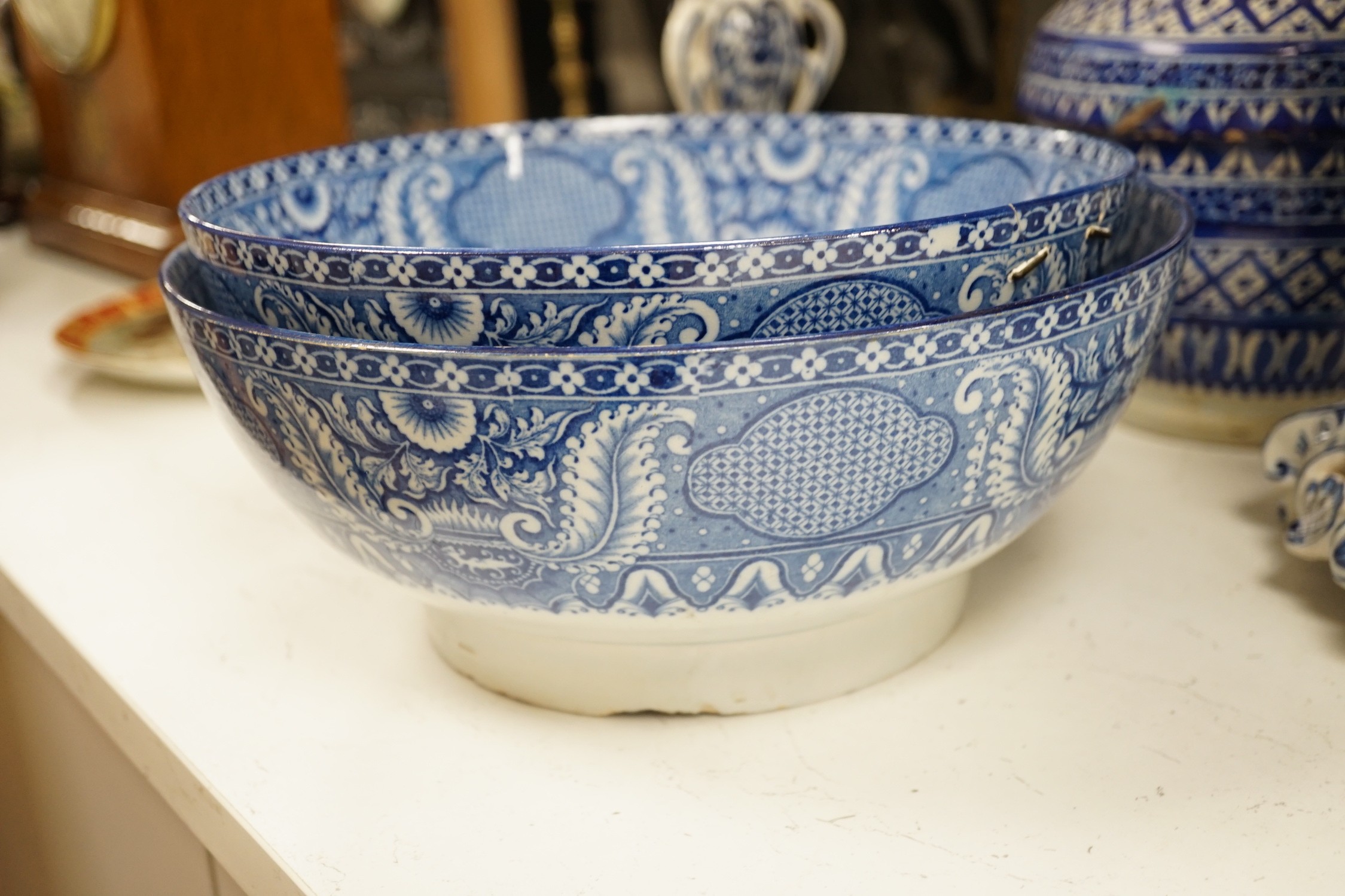 A pair of Delft blue and white candlesticks together with an 18th century Delft bowl, a Moroccan pottery jar with cover, and two pearlware bowls